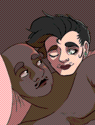 Armond, a chubby, dark skinned man, is laying in bed with his best friend, Luce, a smaller, skinnier, pale skinned man with short, black hair and deep red lips. They look into each other's eyes with affection, as the room is lit up by the morning light behind them.
